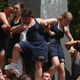 Illustration for article titled Gallery: Greasy Naval Cadets Try To Climb A Lard-Covered Monument
